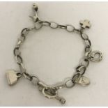 A vintage style belcher chain charm bracelet with charms. To include shoe, handbag and cross.