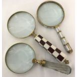 3 large magnifying glasses, one with a chunky faceted glass handle.