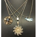 4 silver and white metal necklaces. A filigree flower pendant on a fine curb chain.