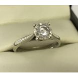 A 9ct white gold diamond solitaire ring. Diamond .33ct. Full hallmarks to inside of band.