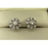 A pair of 18ct white gold & diamond set, flower design stud earrings by Luke Stockley, London.