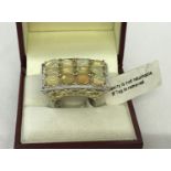 A silver dress ring by TGC with gilt detail to mount set with 12 oval opals.