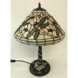 A tiffany style table lamp with leaded glass shade and lamp base.