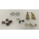 5 pairs of silver stone set earrings in drop and hoop styles.