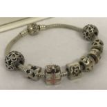 A 925 silver Pandora charm bracelet with 8 charms. Complete with original bracelet box.