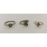 3 silver dress rings each set with amber.