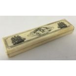 A small Scrimshaw style bone box with hinged lid and carved detail to top.