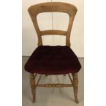 A vintage pine balloon/square back bedroom chair with turned legs and red velvet upholstery.