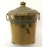 A vintage brass lidded coal bucket with pierced work detail around side and raised on bun feet.