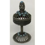 A white metal oriental style filigree pedestal stand trinket box. With turquoise glass decoration.