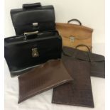 A collection of vintage brief cases and document wallets.