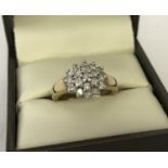 A 9ct gold .50 ct diamond cluster dress/engagement ring. Size I.