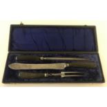 A cased Edwardian 3 piece carving set with faux horn handles and silver mounts.