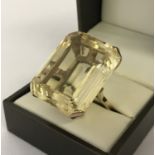 A very large emerald cut Citrine and 9ct gold dress ring. Citrine approx. 12+ ct.