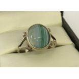 A vintage gold on silver dress ring set with a green banded agate cabochon stone. Ring size N½.