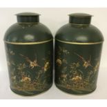 A pair of painted green tole ware, lidded tea jars with hand painted floral and bird design.