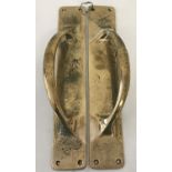 A pair of brass door handles mounted onto finger plates, with curved corners and 4 fixing holes.