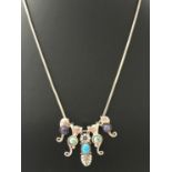 A Southwestern silver and natural stone necklace designed by Carolyn Pollock.