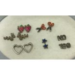 6 pairs of silver and white metal stud earrings. All with butterfly backs.