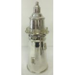 A large silver plated cocktail shaker in the shape of a lighthouse.