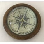 A wooden framed glass dome topped desk compass.