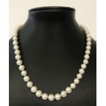 A 16" knotted freshwater pearl necklace with 14ct gold pierced work clasp.