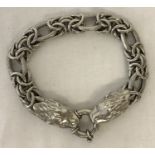 A decorative silver chain bracelet with lion head fixings and round spring clasp.