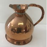 A Georgian copper 1 gallon ale jug of bulbous form with leaded stamped mark and dovetail joint.