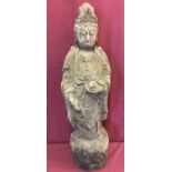 A large carved wooden figurine of an Oriental deity.