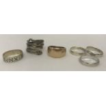 6 silver and white metal band style rings. To include a serpent design ring.