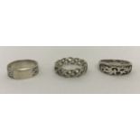 3 men's silver band style rings; 2 with Celtic designs and the other with oriental detail.