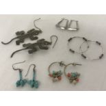5 pairs of silver and white metal earrings in hoop and drop styles.