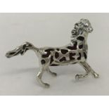 A small sterling silver horse shaped pin cushion with pierced work detail and red velvet cushion.