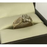A vintage 9ct gold, illusion set diamond dress ring. Pattern to both shoulders.