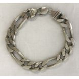 A heavy silver figaro style chain bracelet with lobster style clasp.
