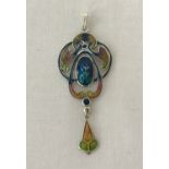 An Art Nouveau style silver pendant with enamelled detail.