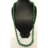 A 34" apple green jade, beaded necklace; knotted between each bead.