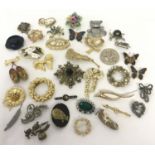 A collection of vintage brooches of various designs, some stone set.