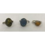 2 amber set silver dress rings together with an opalite set silver dress ring with decorative mount.