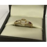 A vintage 18ct gold scrap ring. Set with a white sapphire and a ruby. 3 stones missing from ring.