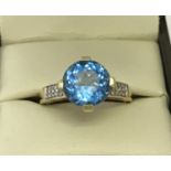 A 9ct gold Swiss blue topaz and diamond dress ring.