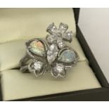 A 925 silver dress ring set with cubic zirconia and opal stones in the shape of a butterfly & flower