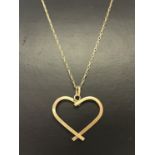 A 9ct gold open heart pendant on a 9ct gold fine rope chain approx. 20" long.