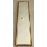 A gilt framed wall hanging mirror.