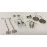 6 pairs of silver and white metal earrings in drop and stud styles.