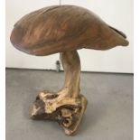 A large rustic ornamental garden mushroom.