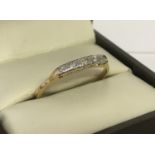 A vintage 18ct gold and diamond eternity style ring. Set with 5 graduating size diamonds.