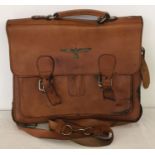 A WWII style leather briefcase with German Kriegsmarine metal badge to front.