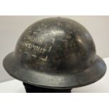 A WWII style London transport Bakelite helmet.
