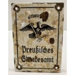 A WWII style German enamel sign. White with black painted lettering, eagle and swastika details.